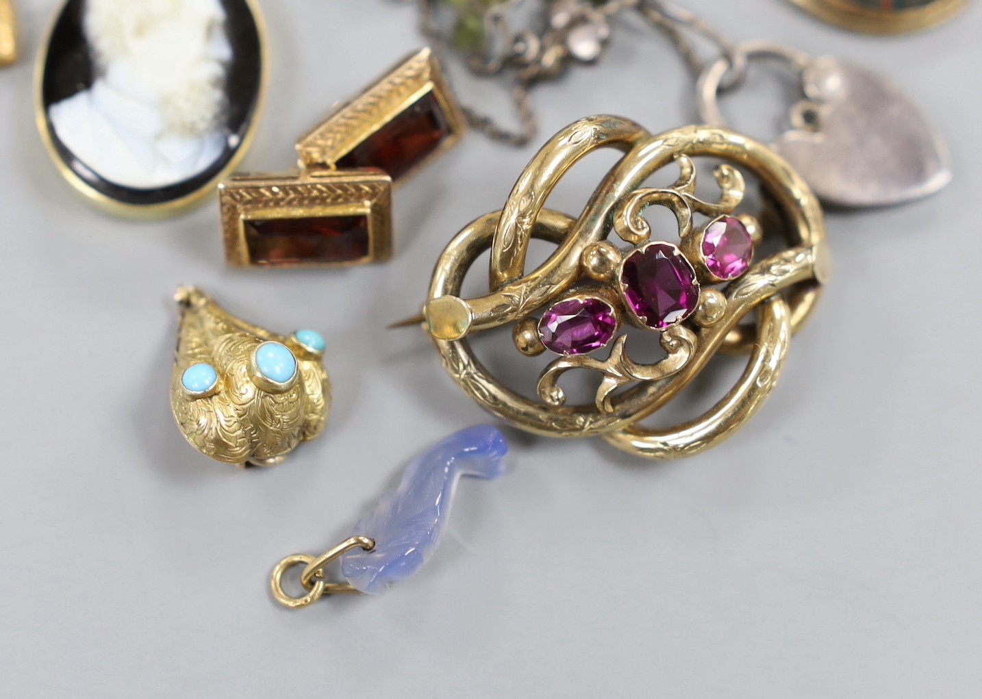 A small group of Victorian and later jewellery including a 1920's silver 'shamrock' bracelet, garnet set scroll brooch, bloodstone set mourning pendant(lacking back), small charms including enamel, sardonyx cameo etc.